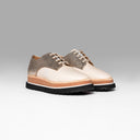 A pair of beige and metallic textured sneakers with a chunky layered sole.